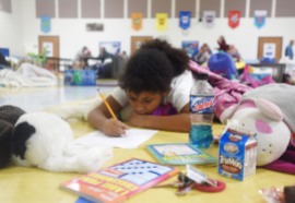 Eight-year-old Arianna Petrocine draws on the floor of the St. Johns County Pet Friendly Shelter at Timberlin Creek Elementary School on Thursday October 6, 2016 after evacuating her Crescent Beach home with her parents, Hazel Petrocine and Richard Petrocine, and their shih tzu Romeo in preparation for Hurricane Matthew. (Christina Kelso/ The St. Augustine Record)