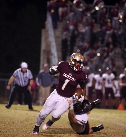 St. Augustine running back Jahq Russell pushes past Navarre linebacker Xavier Fernandez during a Region 1-61 final on Friday, November 25, 2016 at St. Augustine. (Christina Kelso/ The St. Augustine Record)